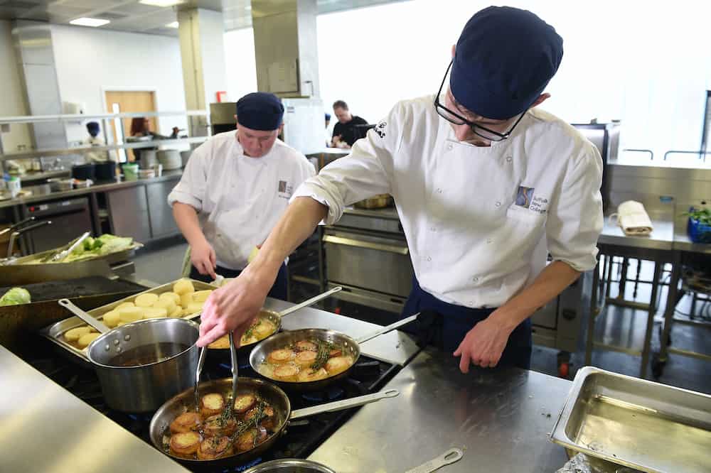 Two catering learners working in the kitchen
