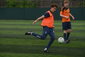 Two male learners playing football at the Ipswich campus.