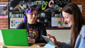 Two learners using laptops in the learning curve.