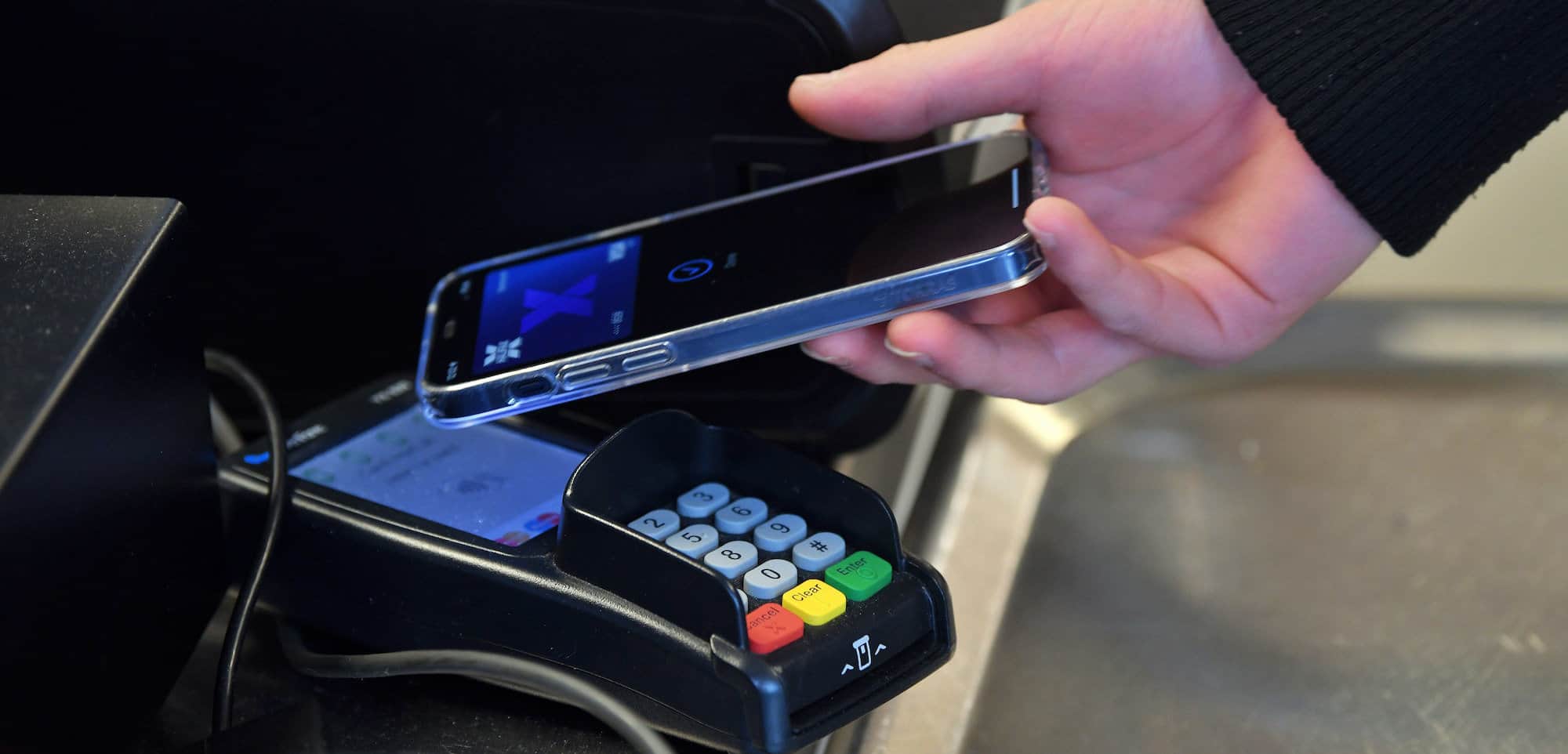 Learner paying on phone.