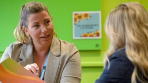 A student support advisor talking to a school leaver or current learner