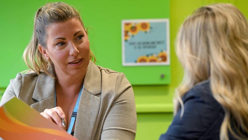 A student support advisor talking to a school leaver or current learner