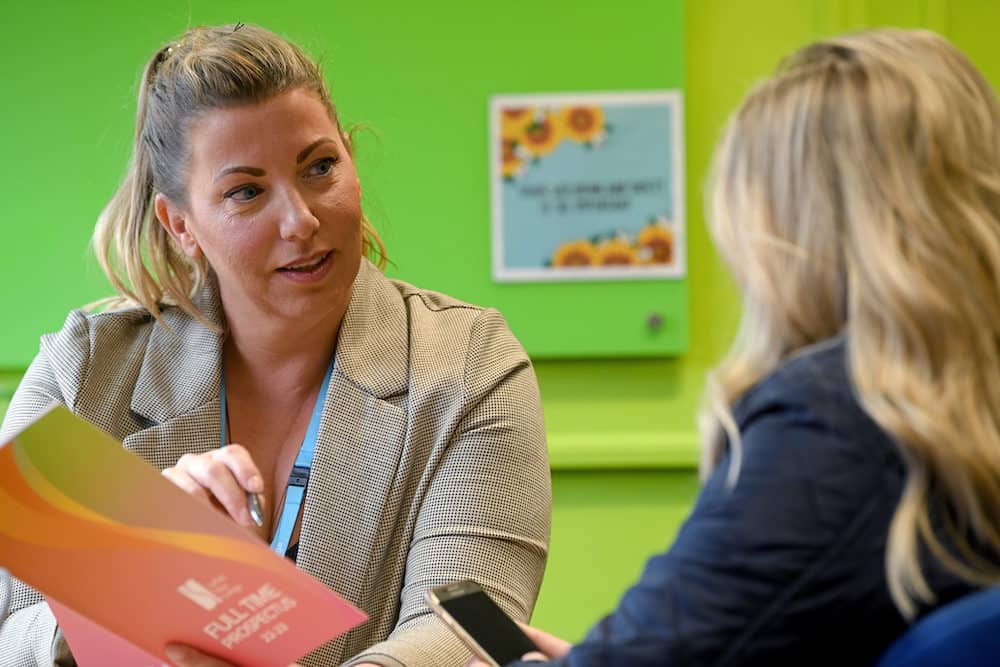 A student support advisor talking to a learner