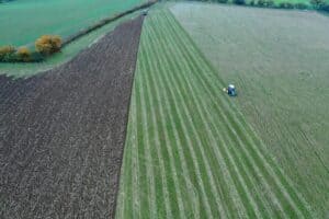 Drone photo of learners driving tractors on field.