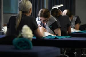 Learner performing treatment on client