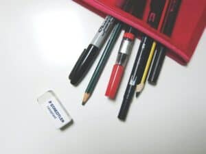 A close up photo of stationery and a pencil case