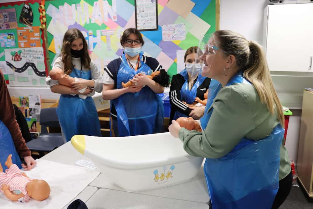 Lecturer demonstrating child bathing techniques
