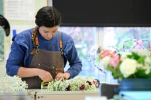 An adult learner in a floristry class
