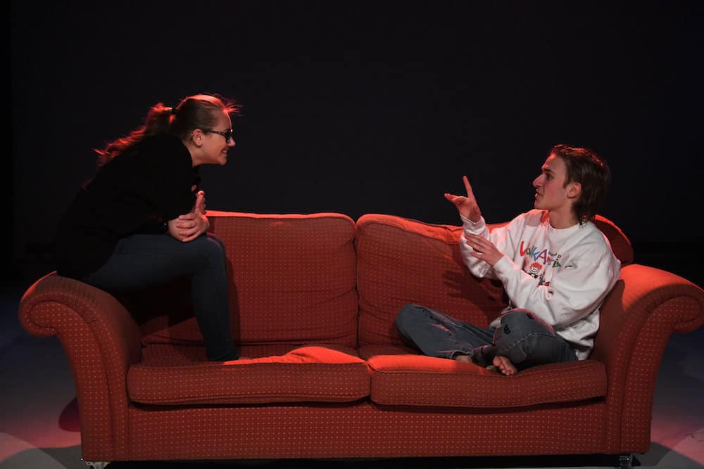 Two learners sitting on a sofa during a production rehearsal