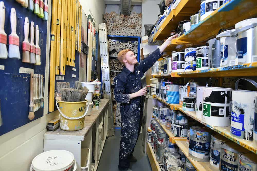 A learner choosing paint from the store