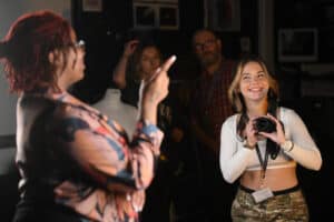 Photography learner taking photo of model in a College photography suite.