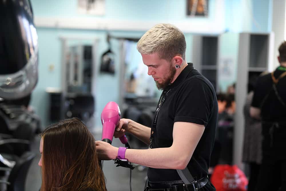 Learner blow drying hair