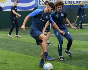 male students on pitch for football sport studies