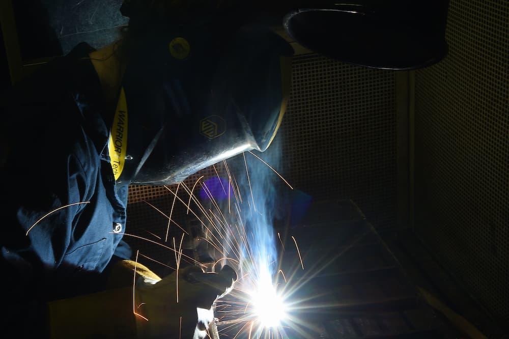 Learner welding in welding workshop