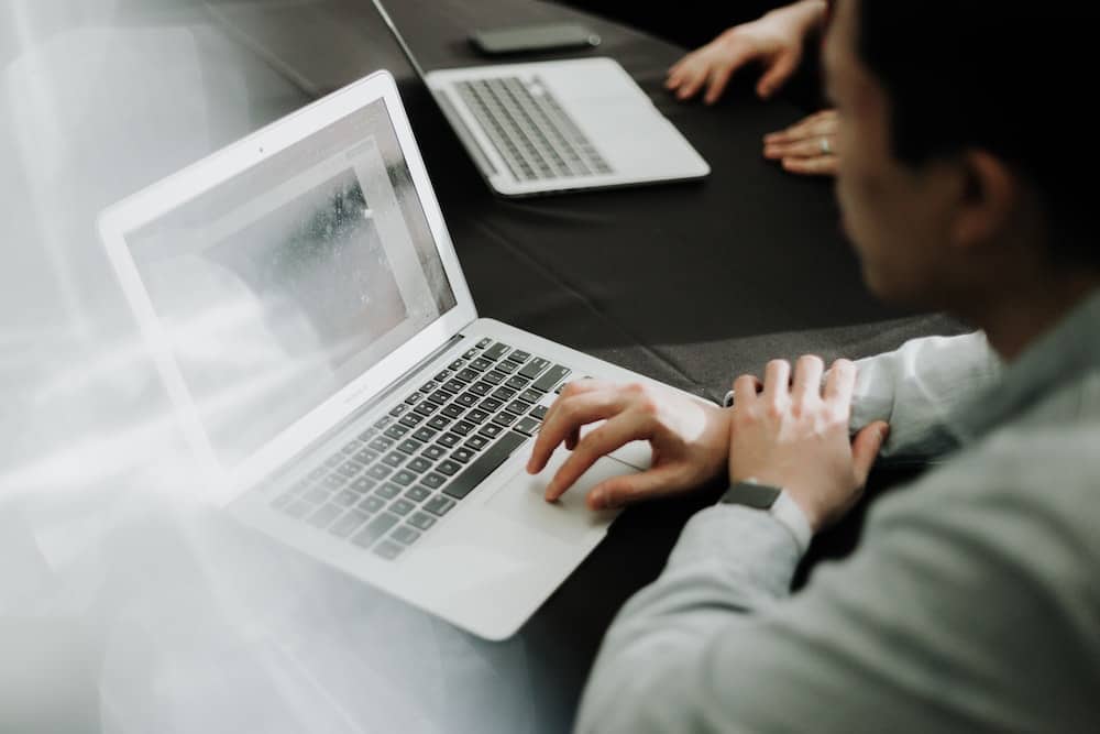 Person using a laptop in a business meeting