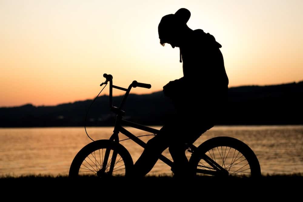 A photo of a teenage on a bicycle