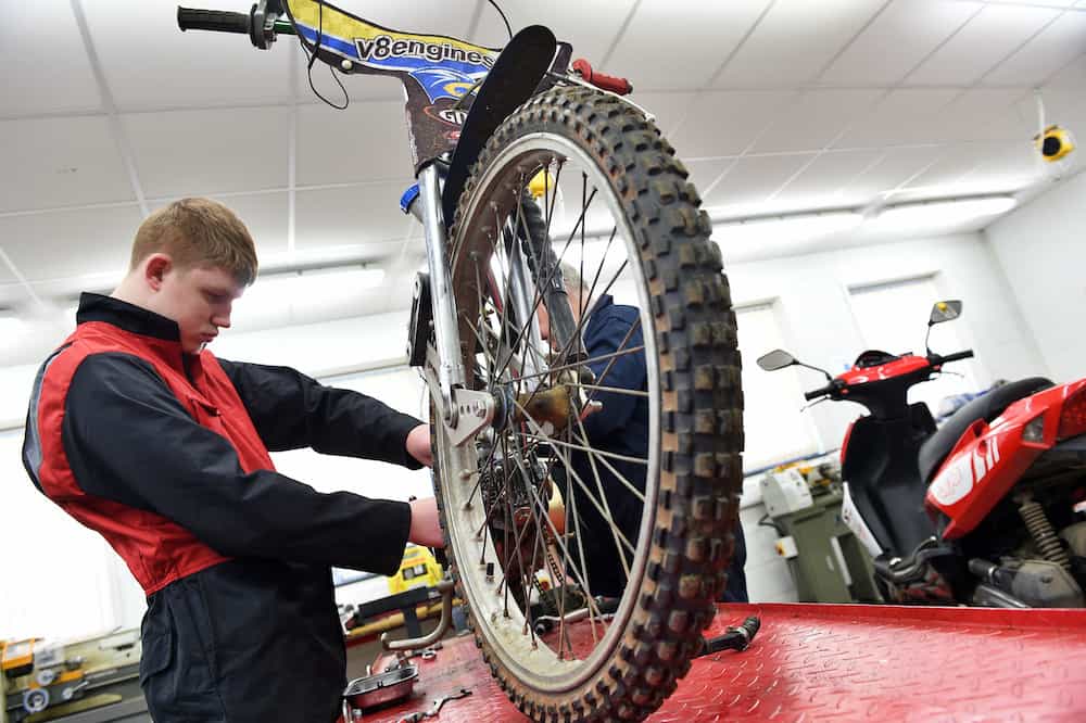 A learner working on a motorcycle in our motor vehicle workshop