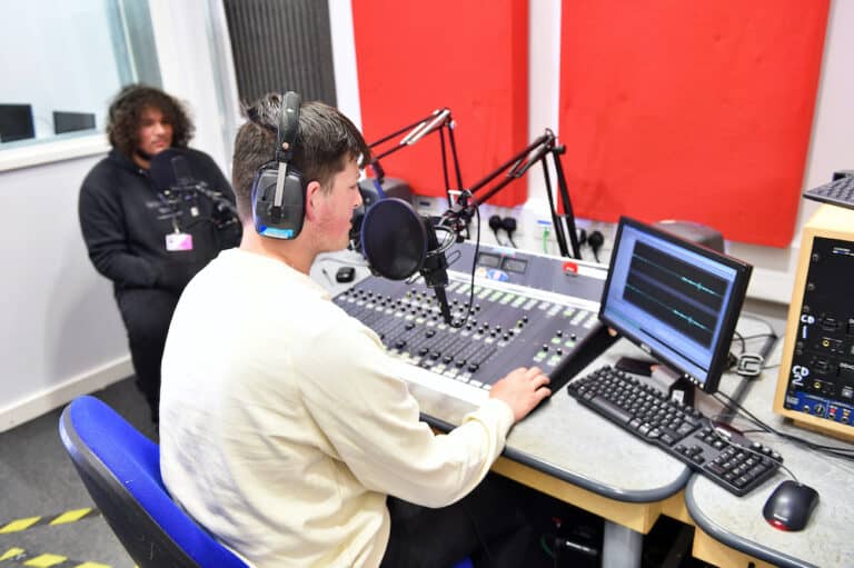 Two media learners using the College radio studio