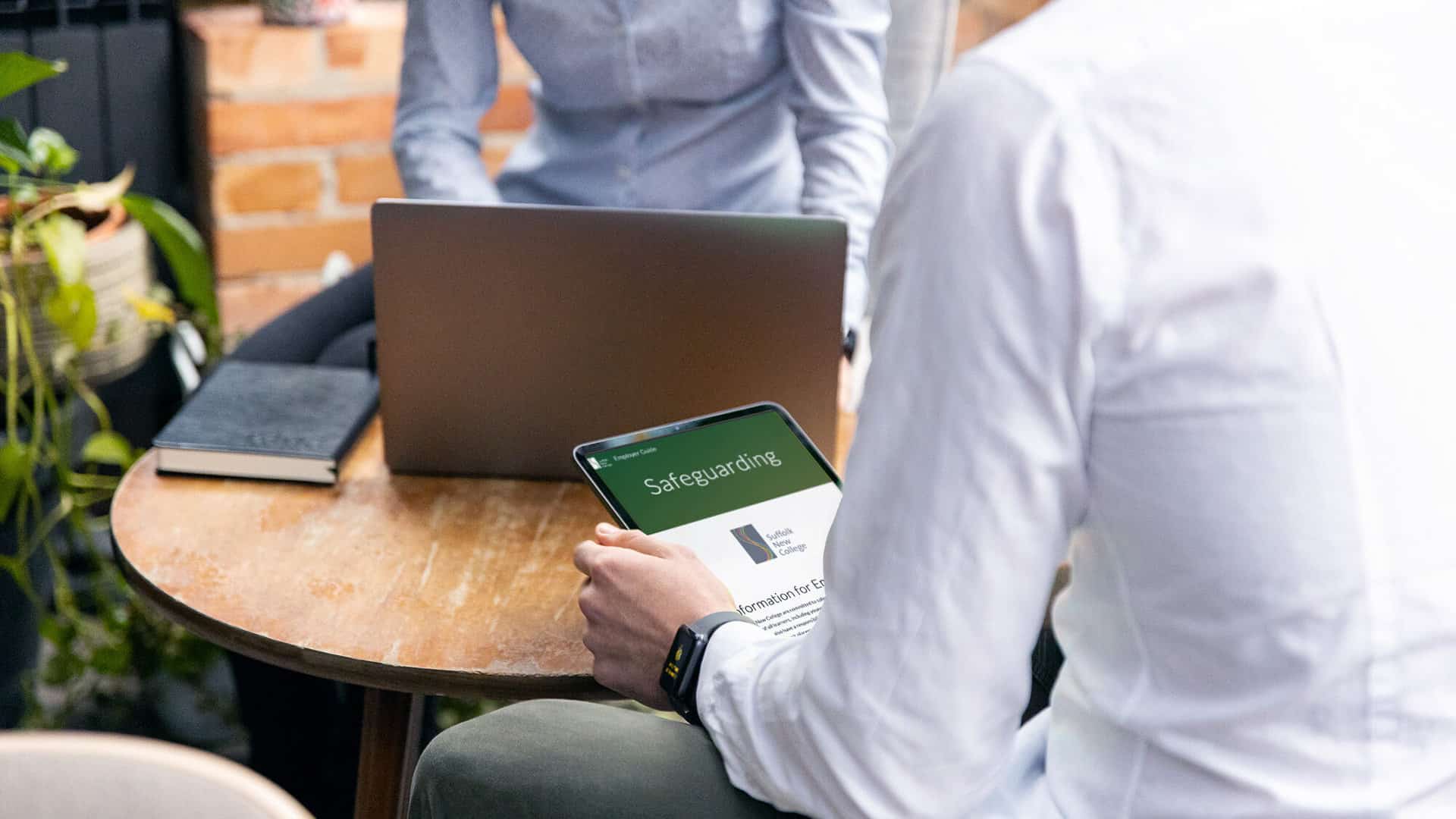 A person using an iPad browsing the Employer safeguarding site
