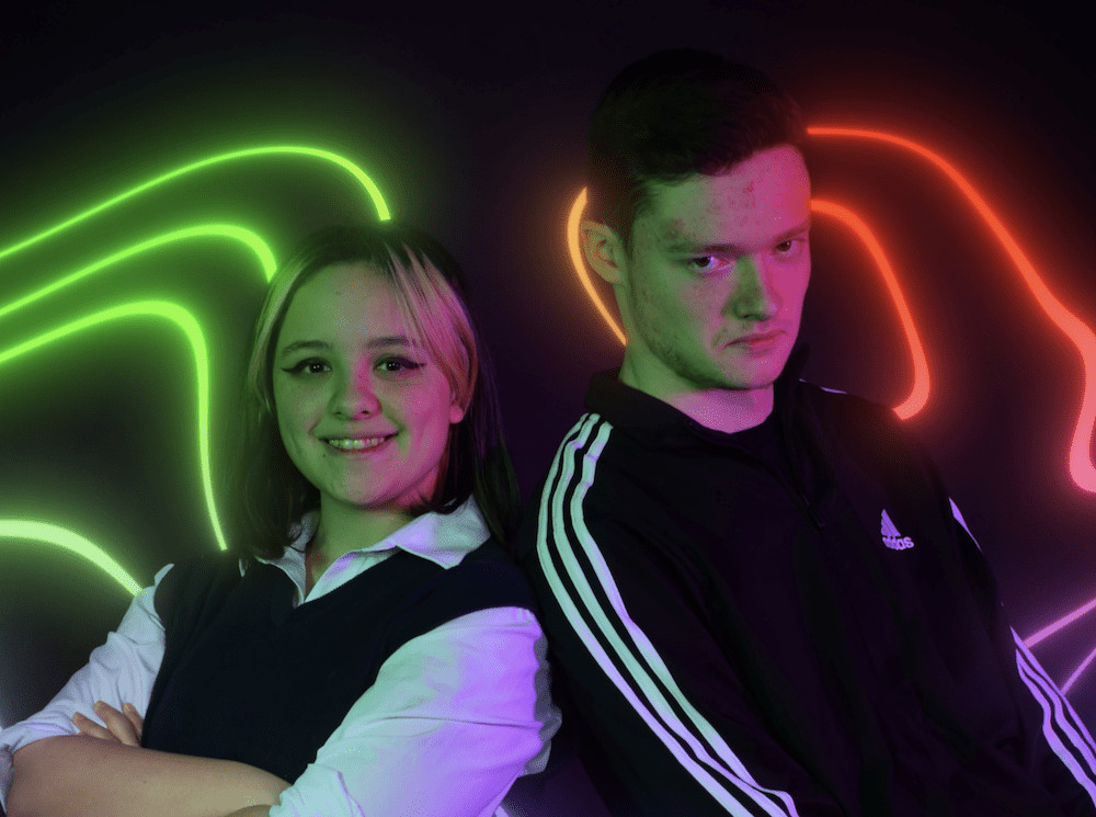 Two presenters against a neon background promoting the Changing Tides event