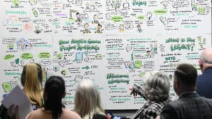 Visitors looking at an illustration about Green Skills at the 2023 Conference