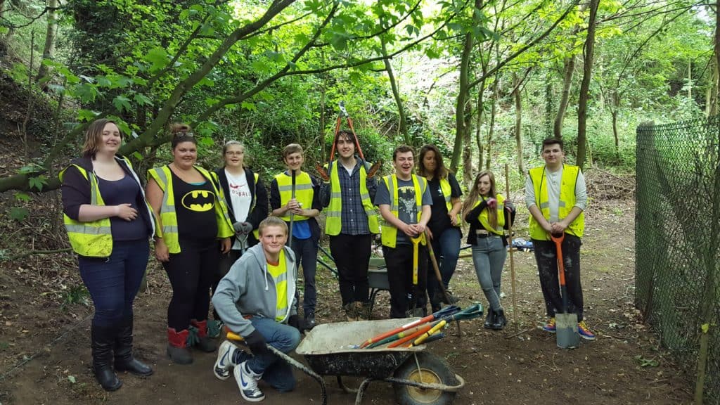 Prince's Trust learners wearing hi-viz in a woodland area