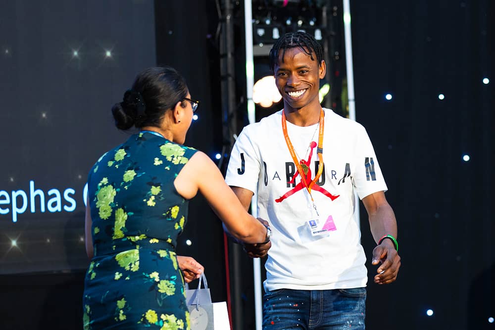 Student Kindi Bah receiving his award for ESOL student of the year