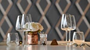 Glasses on table in chefs' whites restaurant