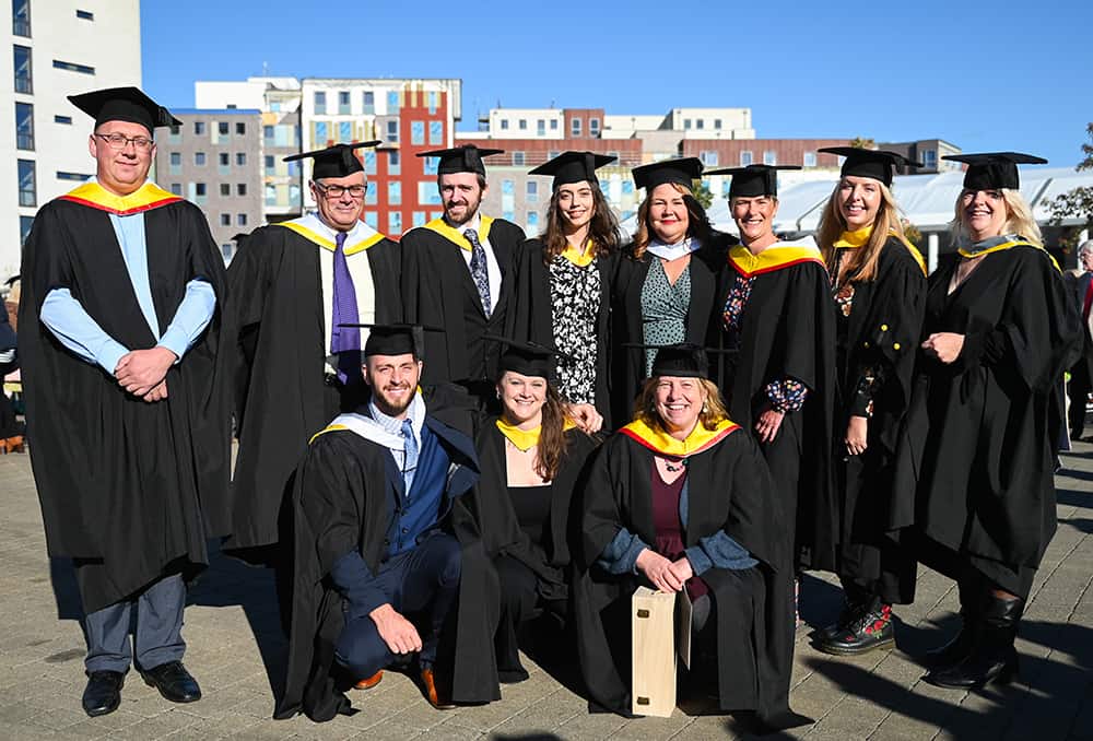 Group of graduates posing for photograph on Ipswich waterfront