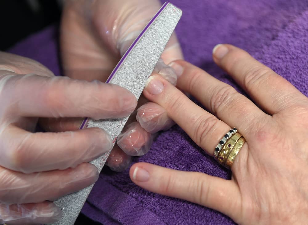 A client having a Nail Therapy session at Aura