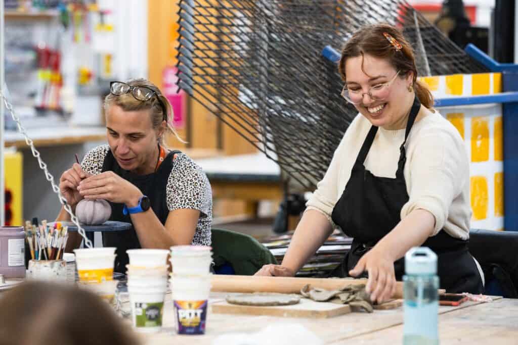 Two Adult Learners In A Leisure Learning Pottery Workshop