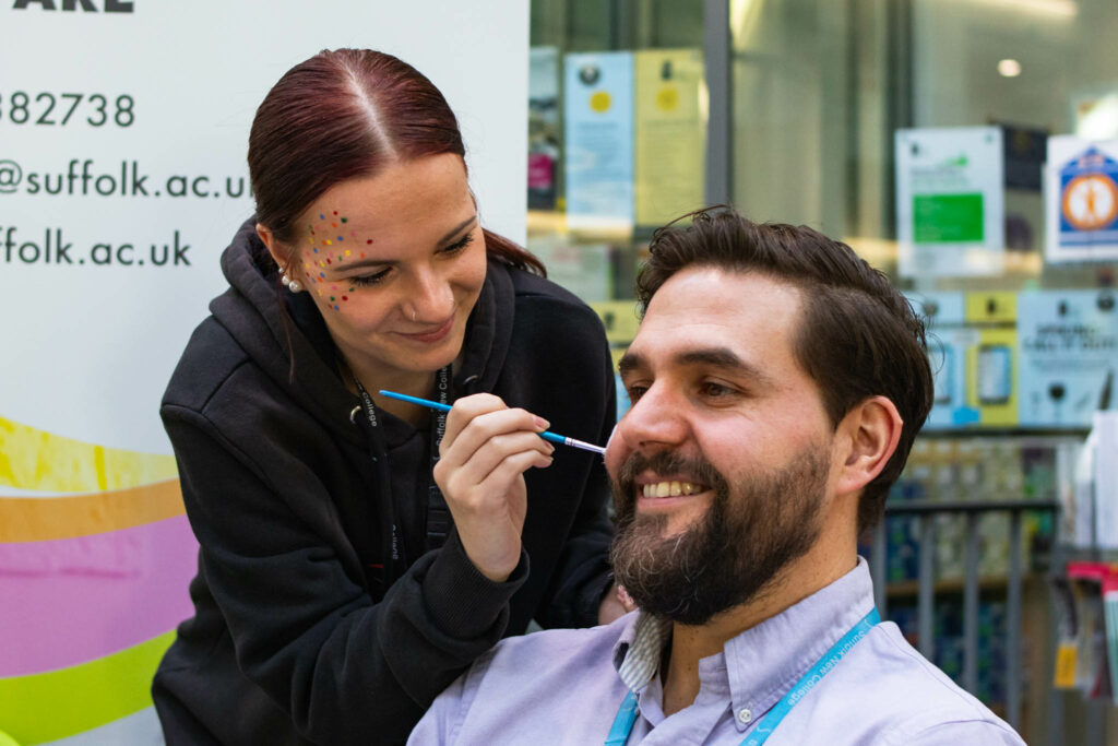 Staff having faces painted to raise money for children in need