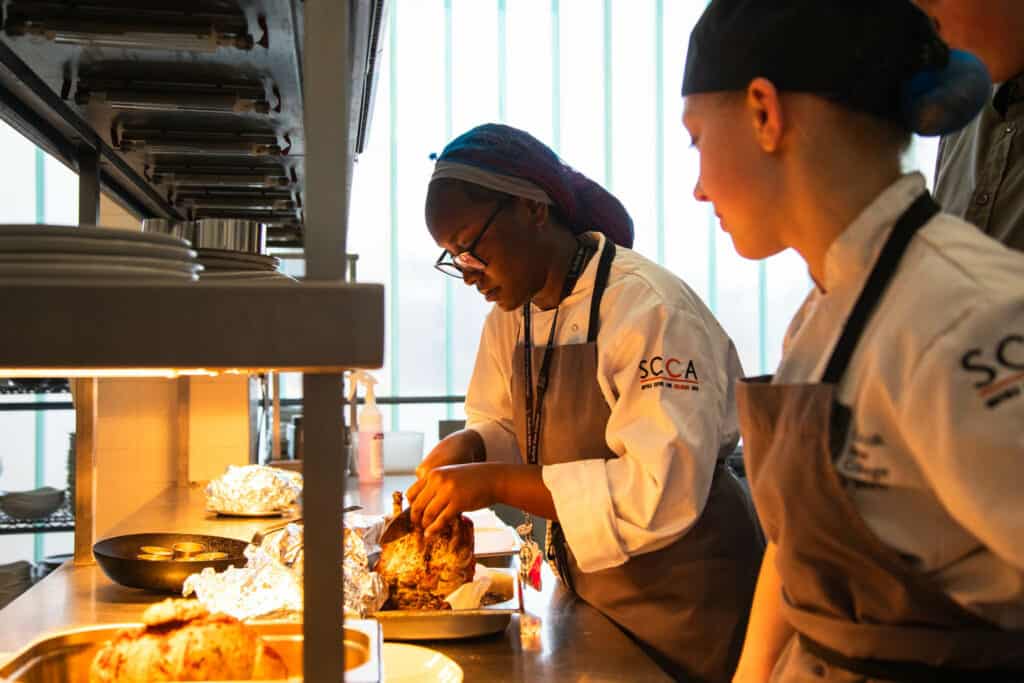 Students preparing food in SCCA kitchens
