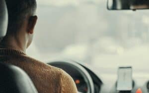 A taxi driver in a car with navigation