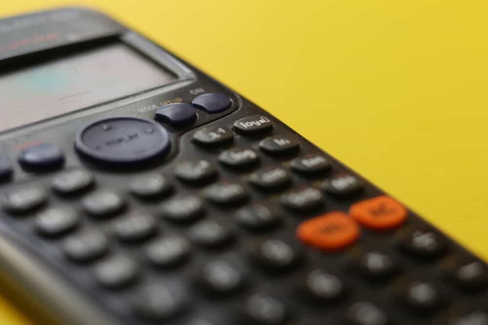 A calculator against a yellow background