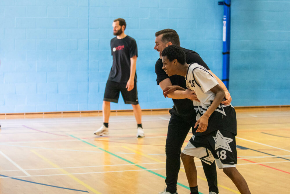 Alan Pease playing basketball with SNC learners