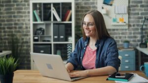 Adult learner using a laptop in a home office