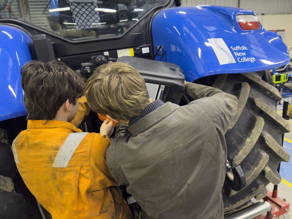 Agricultural Engineering Learners Working On A Tractor