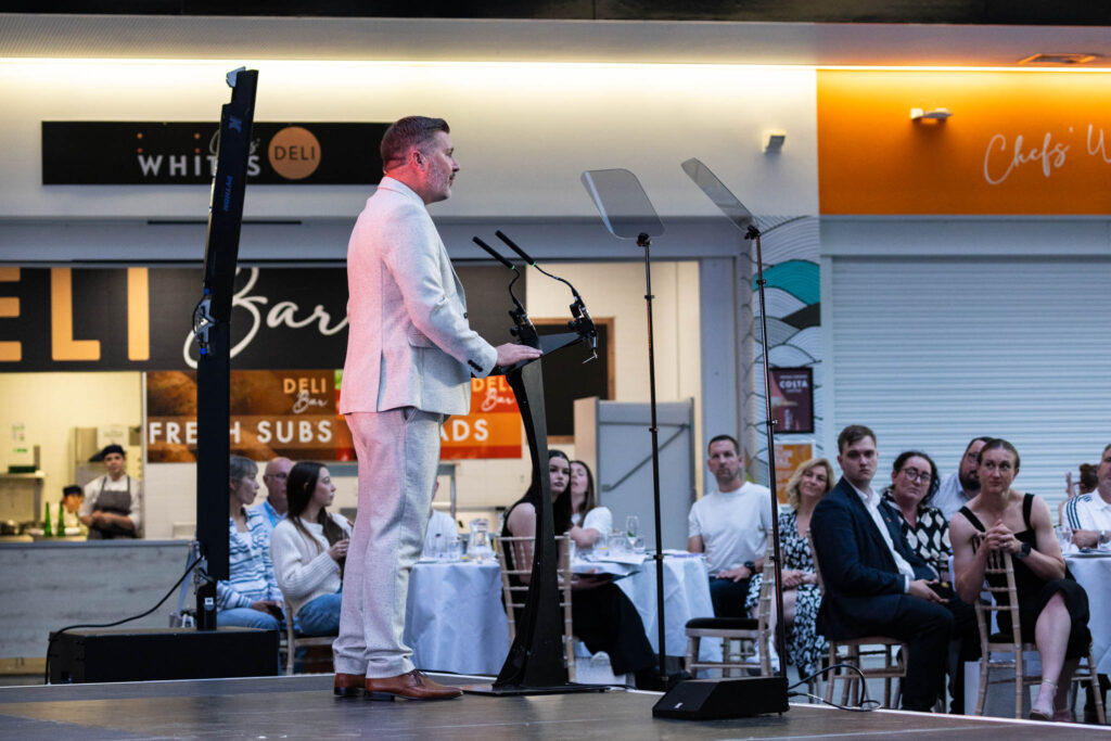 Executive giving speech at awards ceremony
