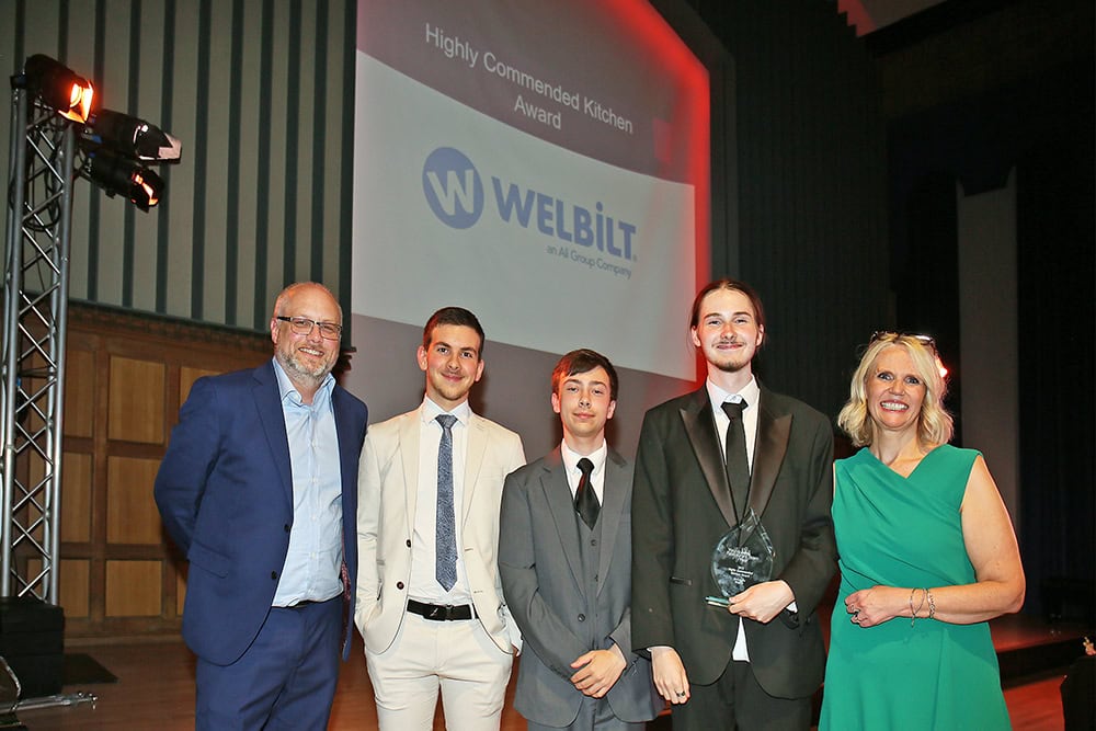 students receiving award at ceremony