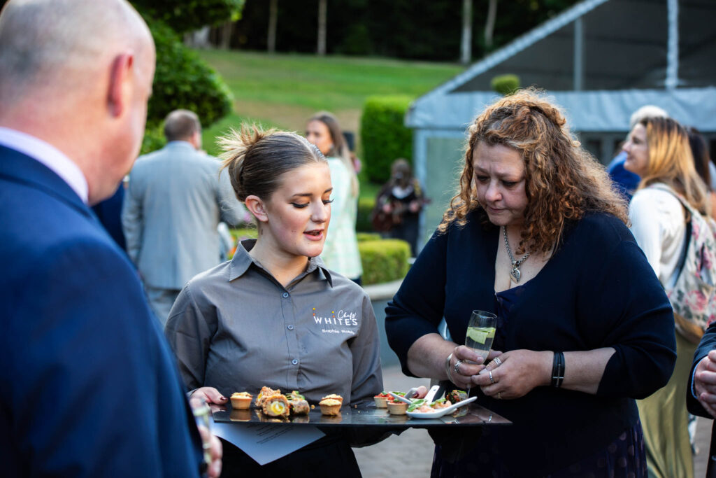 student serving food at college event