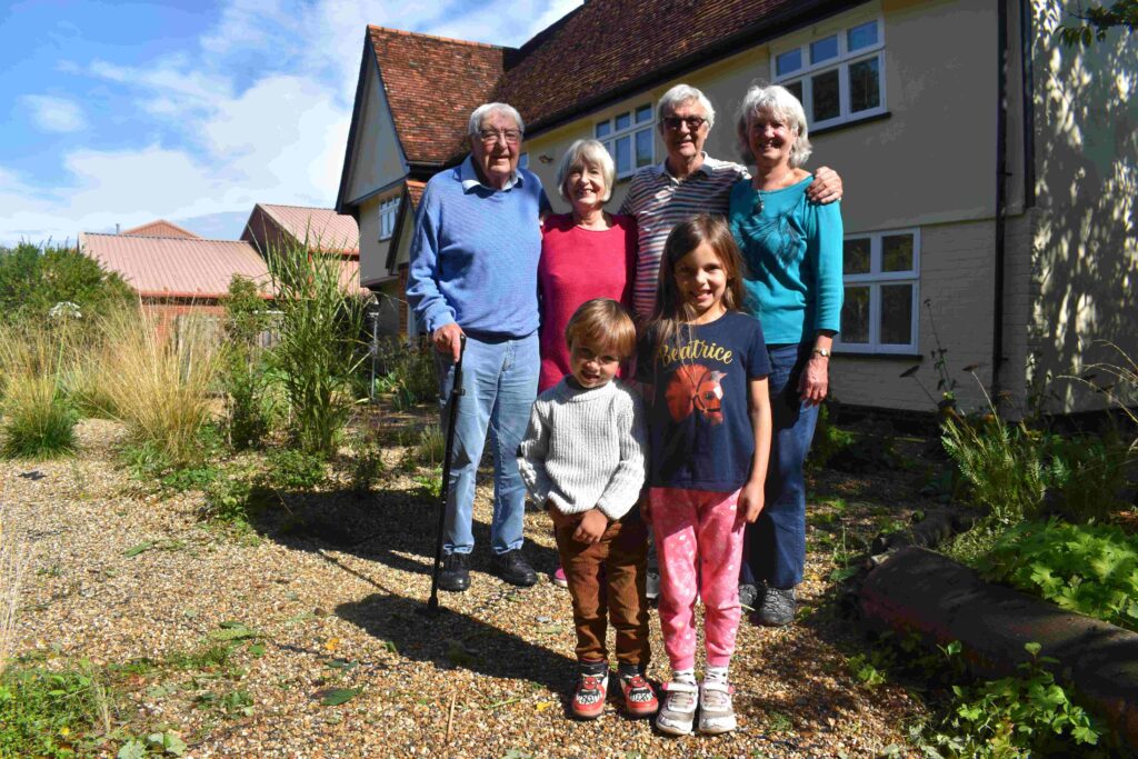 Family outside farmhouse