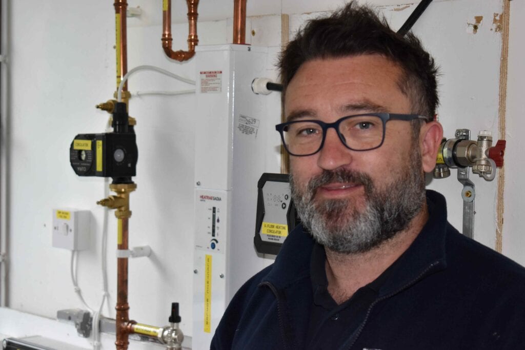 Experienced technician demonstrating heating and plumbing systems at Suffolk New College.