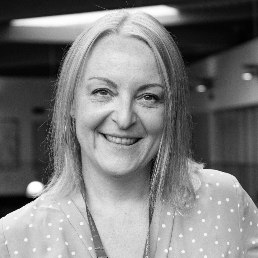 Professional woman smiling at Suffolk New College, education, student support, teaching staff, classroom, college campus, vocational training, further education, college learning environment, Suffolk UK.