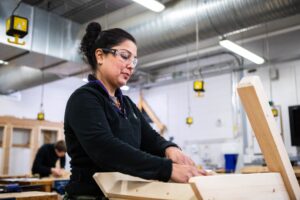 Adult construction student working on a project in Suffolk New College's workshops.