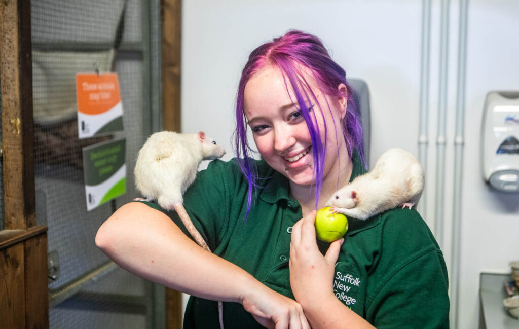 Animal management student holding rats