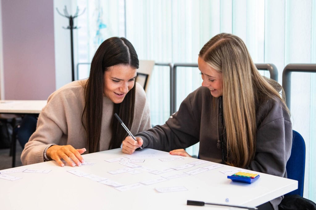 Busy students collaborating during a college workshop at Suffolk New College, showcasing student engagement and modern learning environments in Suffolk.