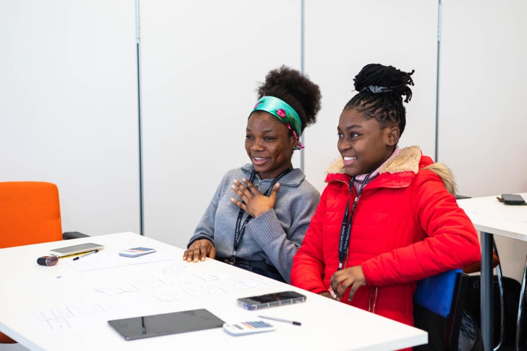 Diverse students participating in a classroom activity at Suffolk New College, showcasing vocational training and student engagement.