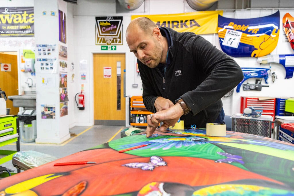 Brightly coloured artwork being created by an instructor at Suffolk New College's body repair centre