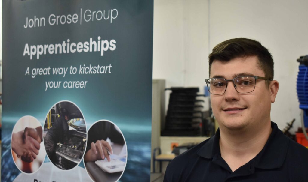 Skilled young man at Suffolk New College participating in apprenticeship programs in a workshop environment.